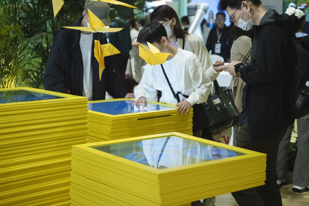 Visitors testing features of the EU Pavilion